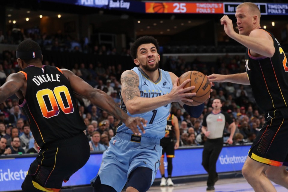 <strong>Memphis Grizzlies guard Scotty Pippen Jr. (1) drives between Phoenix Suns forward Royce O'Neal (00) and center Mason Plumlee, right, on Monday, March 10, 2025.</strong> (Nikki Boertman/AP)