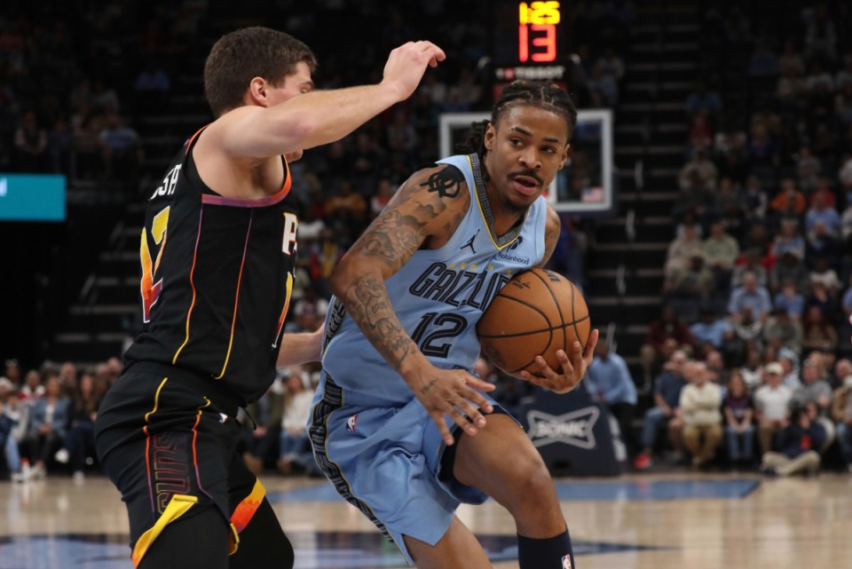 <strong>Phoenix Suns guard Collin Gillespie, left, tries to defend against Grizzlies guard Ja Morant, right, who led Memphis with 29 points on Monday, March 10, 2025.</strong> (Nikki Boertman/AP)