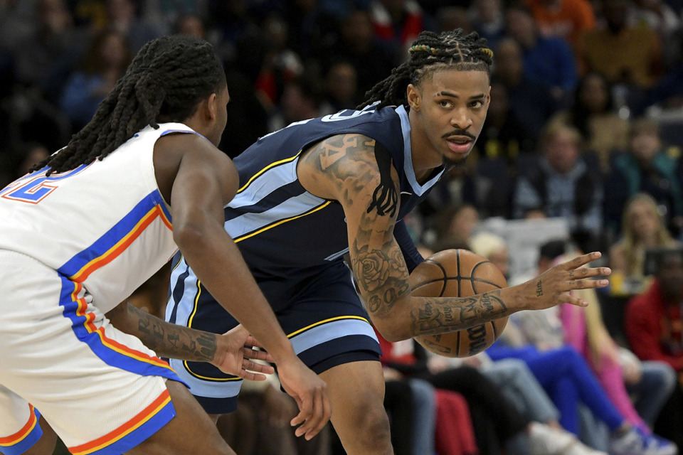 <strong>Memphis Grizzlies guard Ja Morant, right, handles the ball against Oklahoma City Thunder guard Cason Wallace (22) in the first half of an NBA basketball game March 5.</strong> (Brandon Dill/AP file)