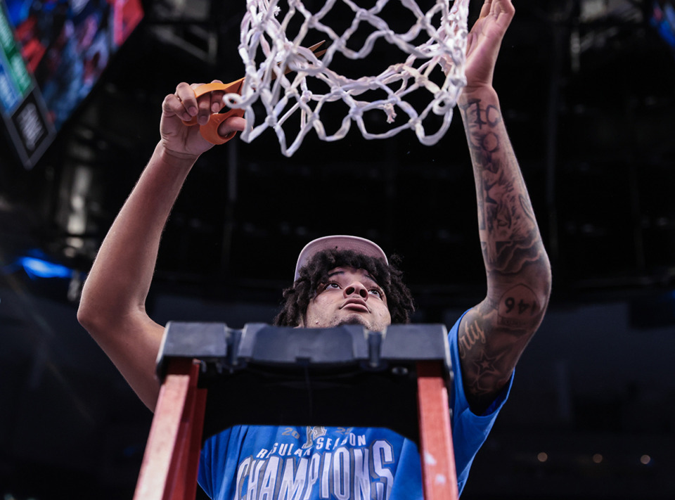 <strong>Memphis Tigers guard PJ Haggerty (4) cuts the nets down a March 7 game against South Florida.</strong> (Patrick Lantrip/The Daily Memphian)