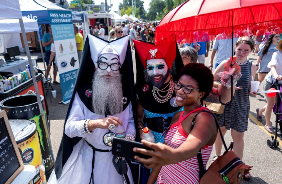<strong>Keenan Luster (right) takes a selfie with Sister Krisco (left) and Sister Fluffy (right) of the 21st Century Order of Queer Clown Drag Nuns during the annual Cooper-Young Festival on Saturday, Sept. 14, 2019. The festival drew thousands of visitors to enjoy live music, local artwork and food.</strong> (Houston Cofield/Special To The Daily Memphian)