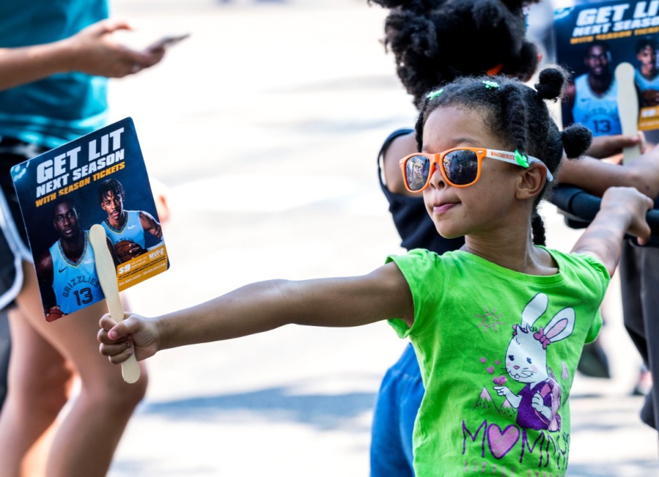 <strong>Charlotte Jones, 5, listens to live music on Young Avenue during the annual Cooper-Young Festival on Saturday, Sept. 14, 2019. The festival drew thousands of visitors to enjoy live music, local artwork and food.</strong> (Houston Cofield/Special To The Daily Memphian)