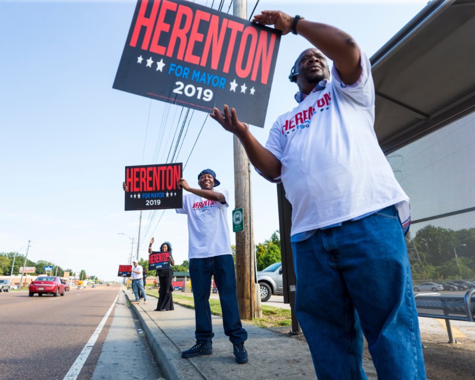 <strong>Michael Foster (right to left), Chris Otis, Dr. Carnita Atwater and Calvin Atwater flash signs as drivers pass in front of Memphis mayoral candidate Willie Herenton's electoral base in South Memphis on Sept. 14, 2019.</strong> (Ziggy Mack/Special to The Daily Memphian)