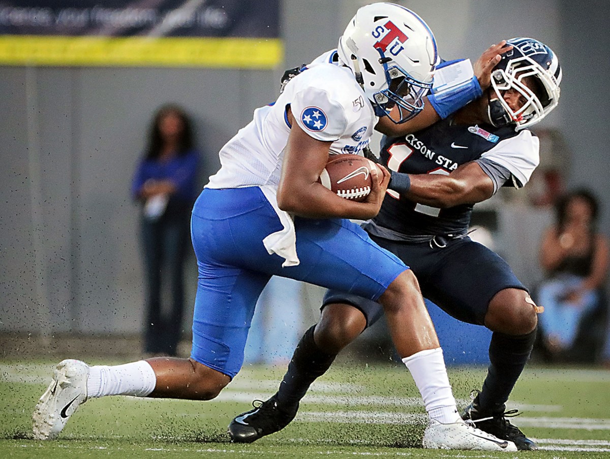 <strong>Tennessee State quarterback Octavious Battle (8) shoves aside a Jackson State University defender during the first quarter of the 30th annual Southern Heritage Classic at Liberty Bowl Memorial Stadium on Saturday, Sept. 14, 2019.</strong> (Patrick Lantrip/Daily Memphian)