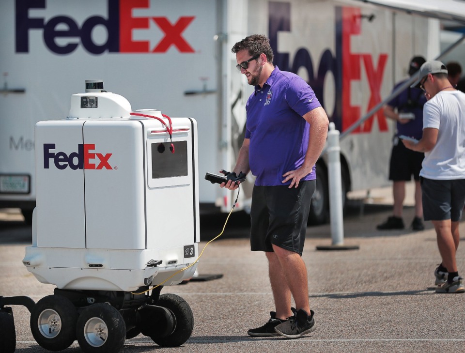<strong>Richard DiPasquale, a member of the FedEx SameDay Bot test team, checks systems on Roxo before starting a test run at the FedExForum on Sept. 4, 2019. </strong>(Jim Weber/Daily Memphian)