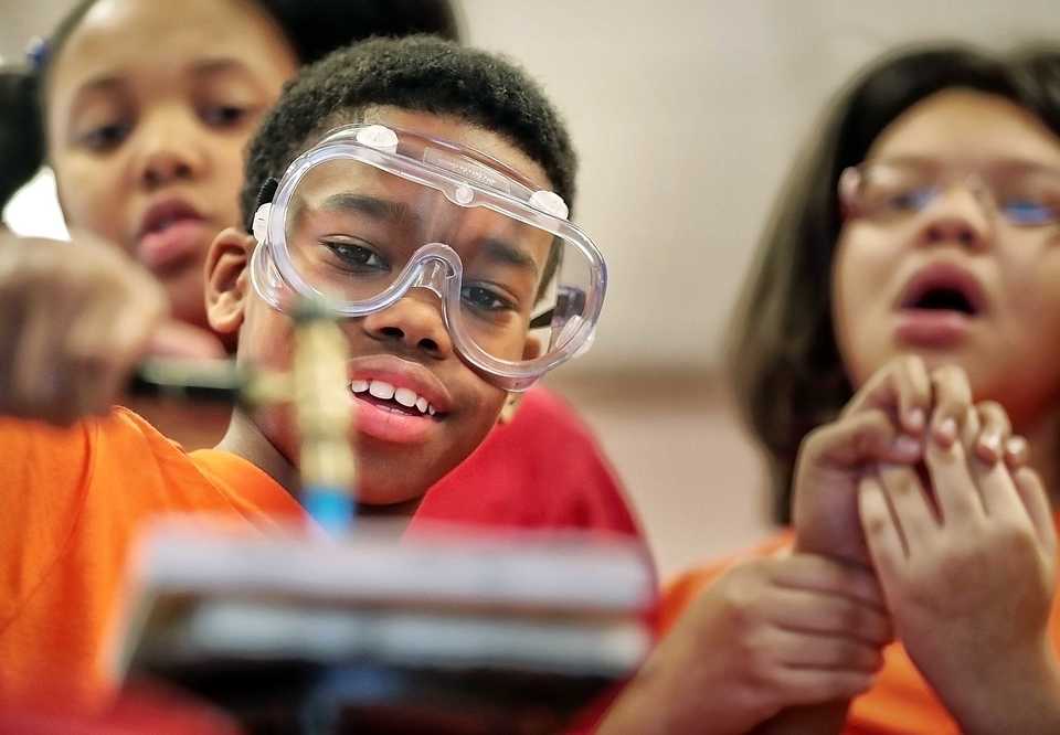 <strong>Rozelle Elementary fifth-grader Malcolm Washington from Kim Warnette's CAPA class learns how to anneal a piece of copper with a welding torch as jewelry artist Obayana Ajanaku teaches an "Art of Science" class on Oct. 24, 2018, at Rozelle. The class is part of a community outreach program by artists involved in the RiverArtsFest going on this weekend in Downtown Memphis.</strong> (Jim Weber/Daily Memphian)