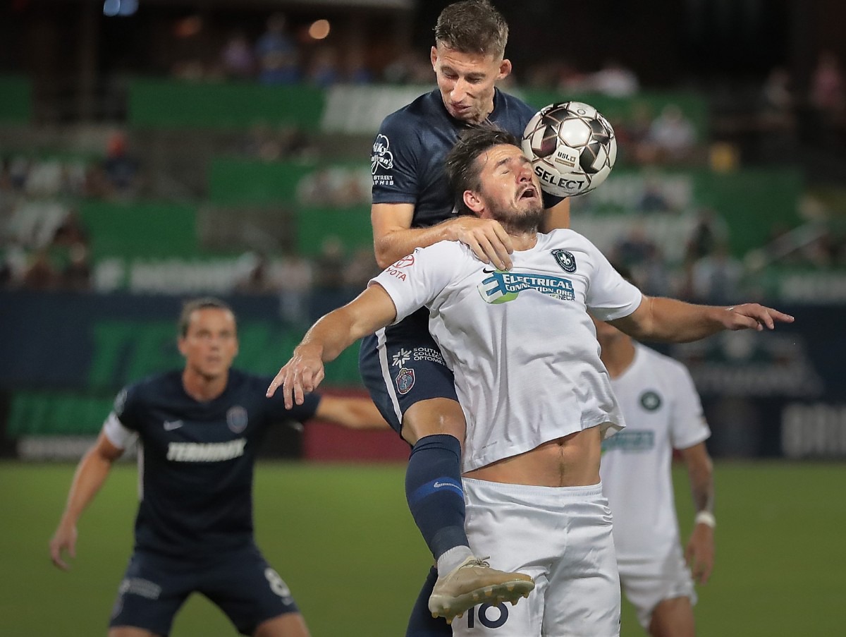 <strong>Memphis defender Josh Morton collides with the St. Louis FC squad's Caleb Calvert (18) during 901FC's 1-0 win over St. Louis at AutoZone Park on Sept. 21, 2019.</strong> (Jim Weber/Daily Memphian)