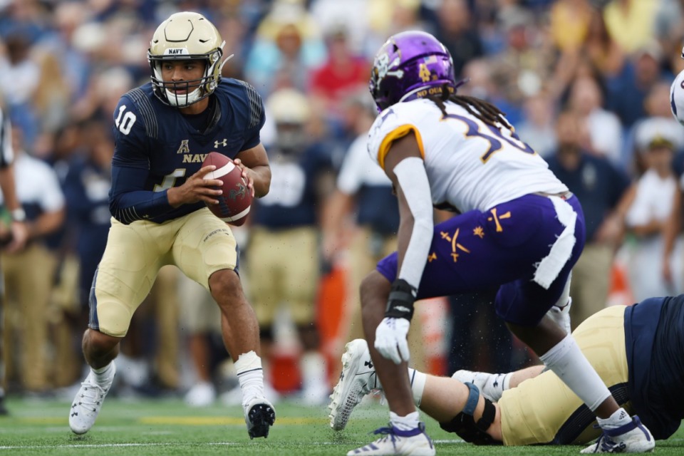 <strong>Navy quarterback Malcolm Perry runs the option offense against East Carolina during a game earlier this season. Navy's ability to run the unusual offense could pose problems for Memphis in Thursday's American Athletic Conference game.</strong> (Gail Burton/AP)