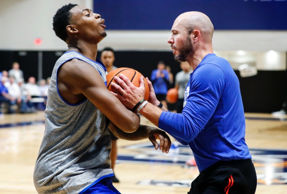 <strong>Tiger forward D.J. Jeffries (left) takes a charging foul while running through drills with assistant coach Cody Toppert (right) Sept. 24.</strong> (Mark Weber/Daily Memphian)