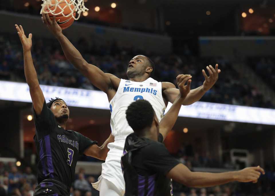<strong>University of Memphis guard Alex Lomax (2) shoots under pressure by LeMoyne-Owen's Tyrone Banks during the Tigers' game against the Magicians at FedExForum&nbsp;in Memphis on Oct. 25, 2018.</strong> (Jim Weber/Daily Memphian)