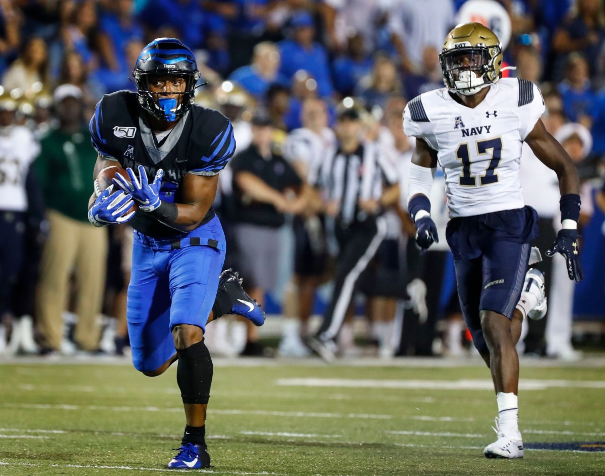 <strong>Memphis receiver Antonio Gibson (left) hauls in a touchdown catch in front of Navy defender Colby Jacques (right) Thursday night.</strong> (Mark Weber/Daily Memphian)