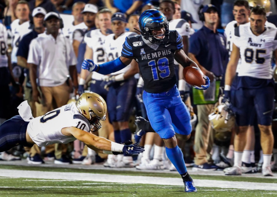 <strong>Memphis running back Kenneth Gainwell (right) scrambles past Navy defender Vincent Thomas Jr. (left) on his way to a 75-yard touchdown at Liberty Bowl Memorial Stadium Thursday, Sept. 26.</strong> (Mark Weber/Daily Memphian)