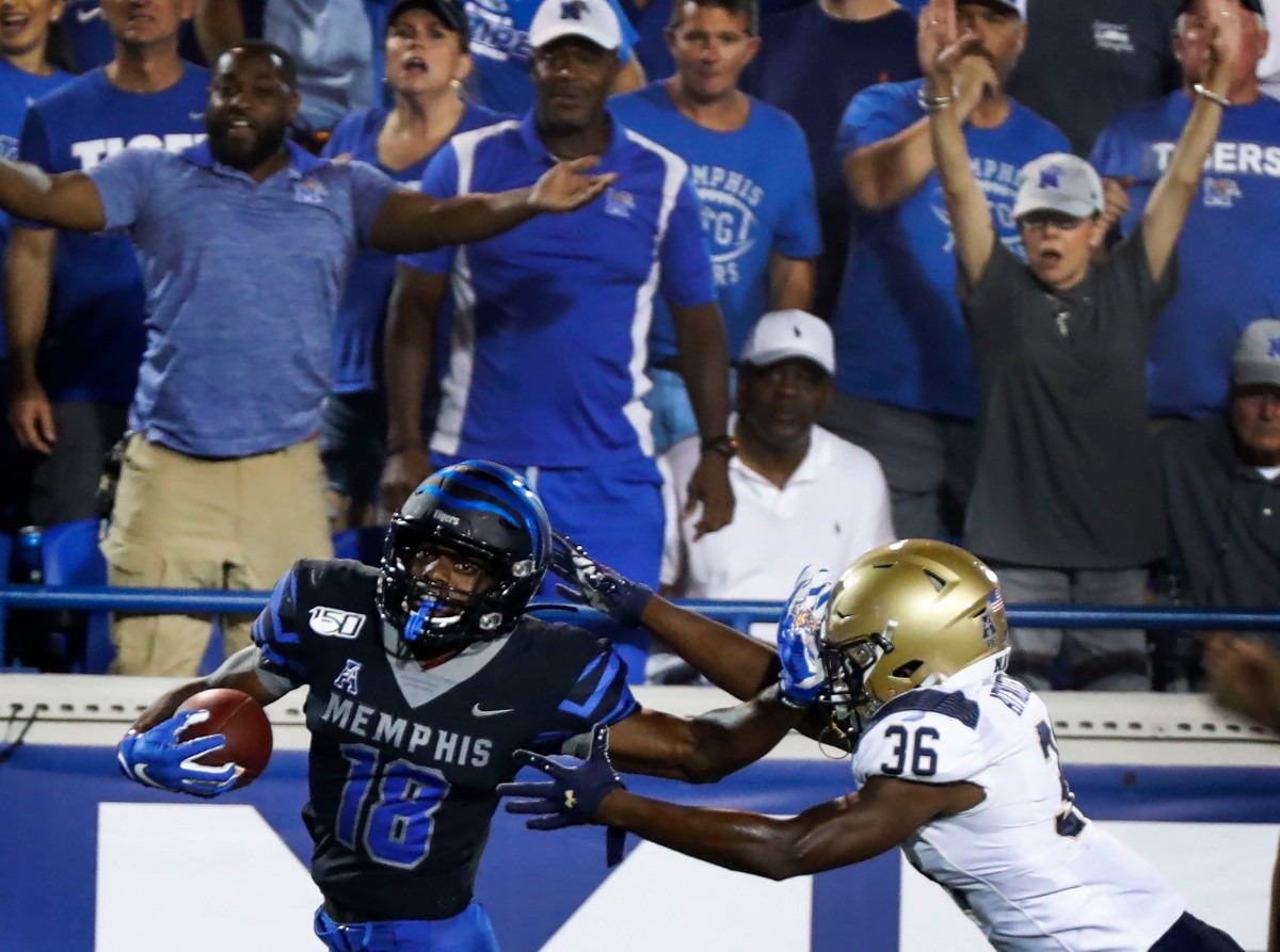 <strong>Memphis punt returner Gabriel Rogers (left) scrambles past Navy defender Derek Atwaters (right) on his way to a 99-yard touchdown at Liberty Bowl Memorial Stadium Sept. 26.</strong> (Mark Weber/Daily Memphian)