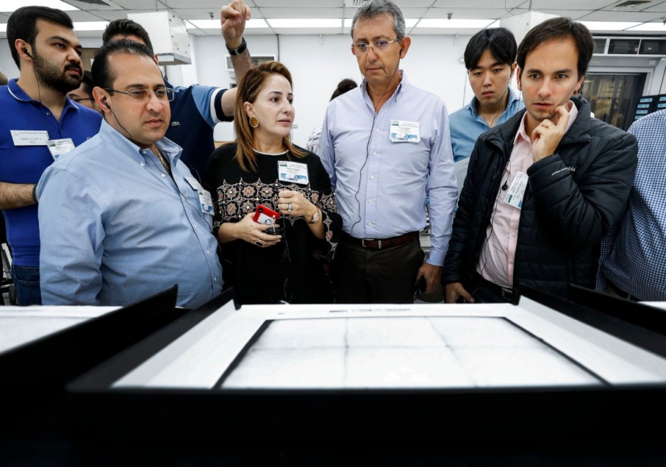 <strong>International textile manufacturing representatives look over cotton samples while touring the United States Department of Agriculture cotton classing office in Bartlett Tuesday, Oct. 1, 2019.</strong> (Mark Weber/Daily Memphian)