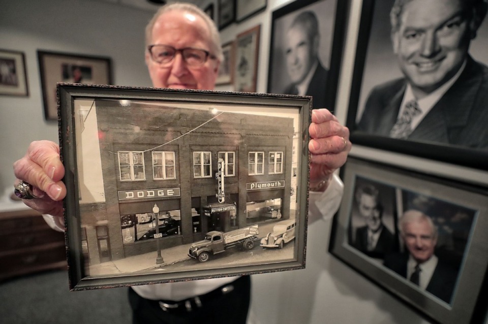 <strong>Chuck Hutton CFO Richard Carney, who has worked for the Memphis car dealership since 1972, holds up a photo from one of the original Chuck Hutton dealerships in Sioux Falls, South Dakota, during an interview on Oct. 4, 2019, at the Chevrolet store in Southeast Memphis.</strong> (Jim Weber/Daily Memphian)