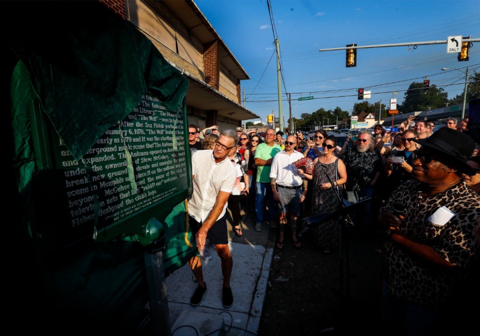 <strong>Former owner of The Antenna Club Steve McGehee (middle) unveils a historical marker honoring the venerable Madison Avenue music venue on Oct. 5, 2019. The club was the epicenter of Memphis' punk and new wave scene in the late '70s and early '80s.</strong> (Mark Weber/Daily Memphian)