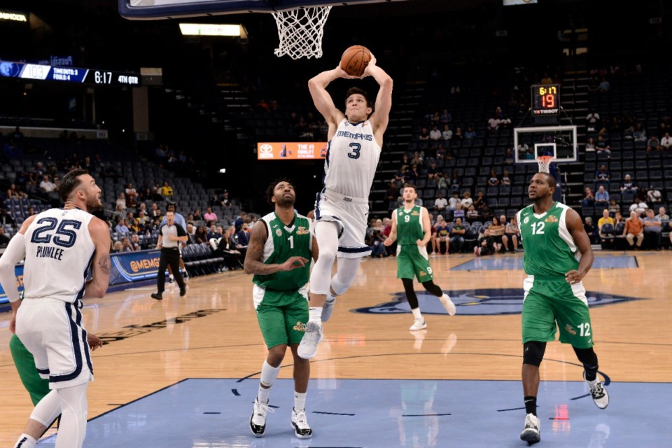 Memphis Grizzlies guard Grayson Allen (3) dunks ahead of Maccabi Haifa guard James Young (1) in the second half of Sunday's preseason game. Allen finished with 18 points, including connecting on 4 of 6 3-pointers. (AP Photo/Brandon Dill)