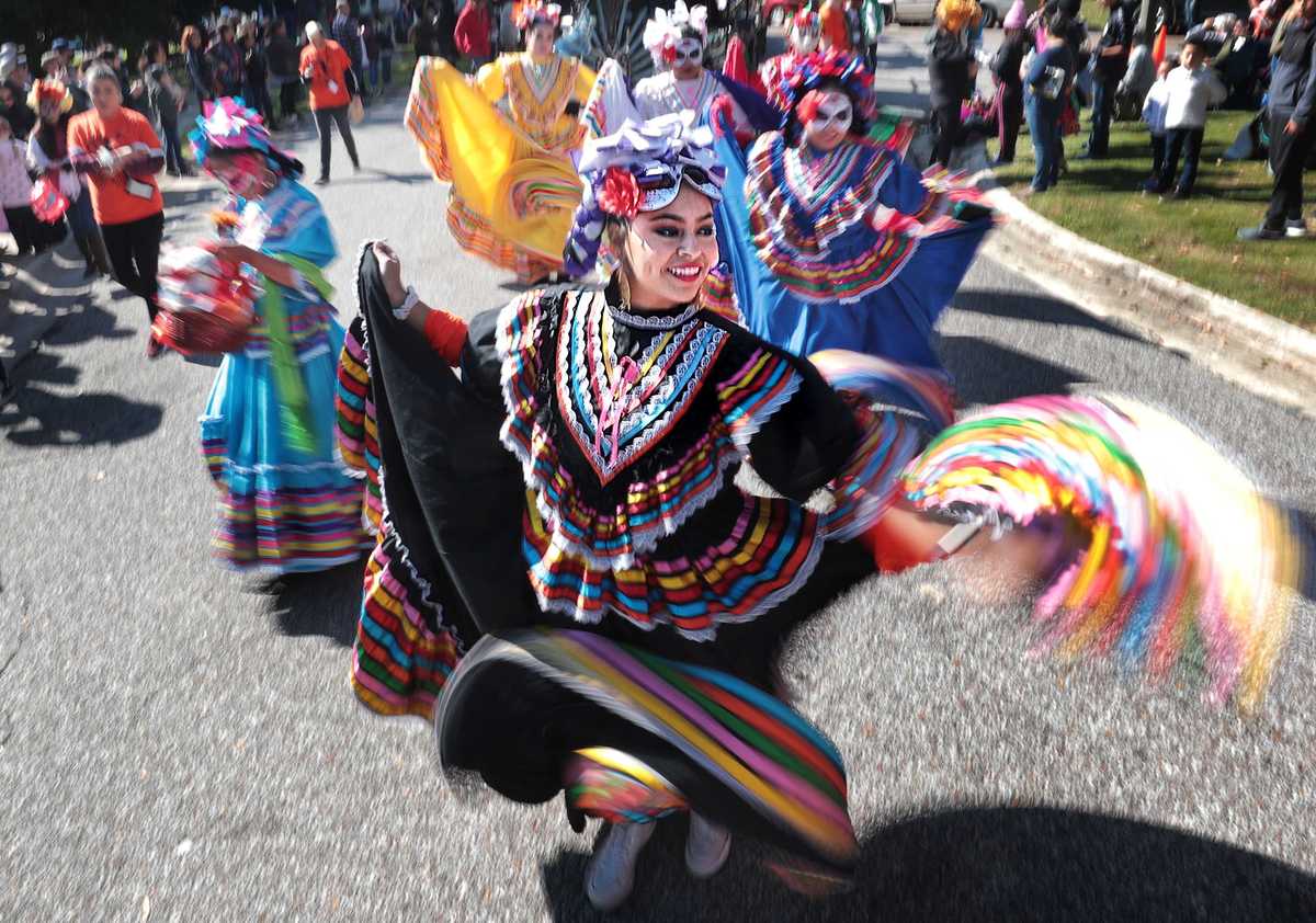 <strong>Jessica Mendoza and fellow dancers with Herencia Hispana enter Overton Park with a flourish during the a Dia de los Muertos (Day of the Dead) parade from Overton Square to Overton Park on Oct. 27, 2018. The parade and fiesta are put on by the Brooks Museum of Art and Cazateatro Bilingual Theatre Group drawing from the Latin American tradition of honoring ancestors and celebrating the cycle of life and death.</strong> (Jim Weber/Daily Memphian)