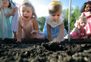 <strong>The kids of Lynn Erickson's pre-K class at Hutchison School in East Memphis smile as they plant carrot seeds in the school's recently expanded garden Sept. 25, 2019.</strong> (Patrick Lantrip/Daily Memphian)