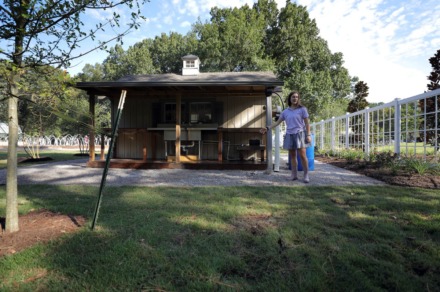 <strong>Hutchison senior Elizabeth Austin shows off the solar powered rain-water catcher/vegetable wash station Sept. 25, 2019, that she personally designed and built at her school.</strong> (Patrick Lantrip/Daily Memphian)