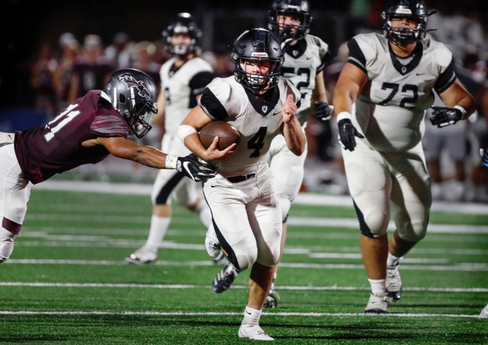 <strong>Houston running back Lincoln Pare (right) scrambles past Collierville's Mario Sanders (left) on his way to a touchdown Oct. 10.</strong> (Mark Weber/Daily Memphian)