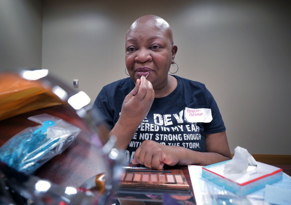 <strong>Angela Palmer checks herself out in the mirror as she puts on lipliner at a Blossom Within session, which is for women currently undergoing breast cancer treatment, helping them with makeup tips, wig fittings, post-surgical attire and healthy living at Baptist Hospital for Women Oct. 11.</strong> (Patrick Lantrip/Daily Memphian)