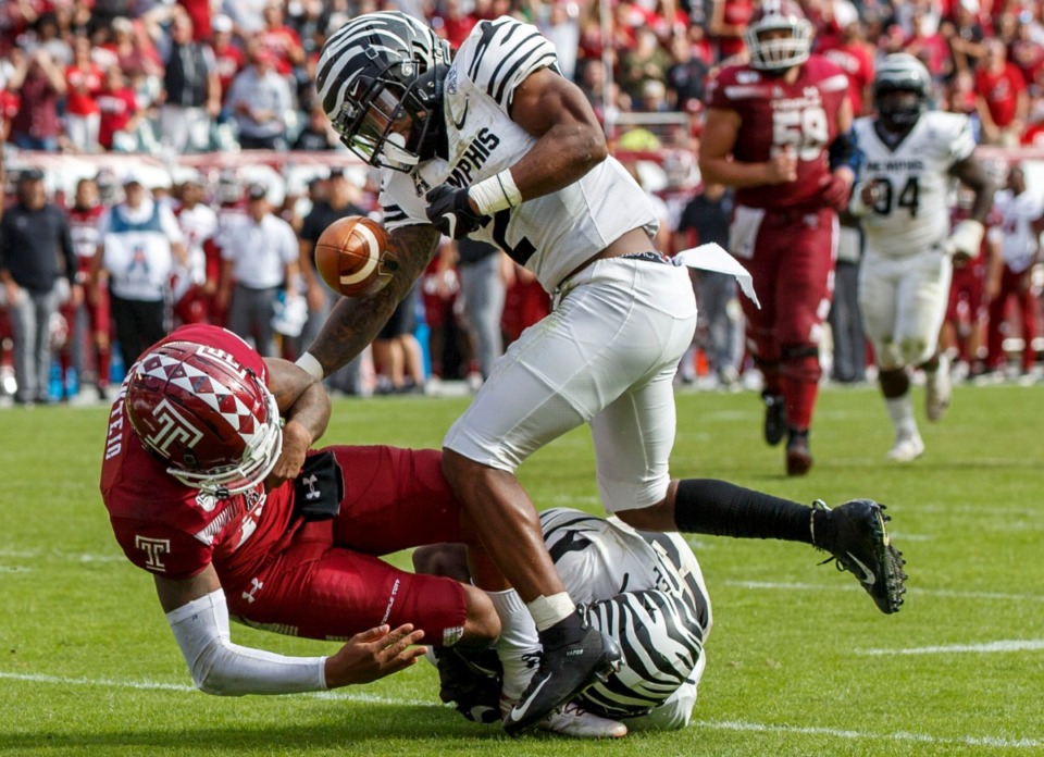 <strong>Memphis defensive back T.J. Carter (2) strips the ball away from Temple quarterback Todd Centeio (16) as he is tackled by Memphis linebacker JJ Russell (23) during the second half of an NCAA college football game on Saturday, Oct. 12, 2019, in Philadelphia. Temple won 30-28.</strong> (AP Photo/Chris Szagola)