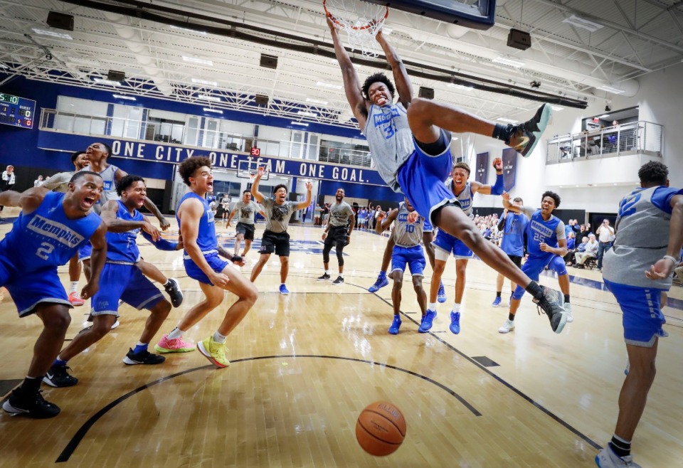 <strong>University of Memphis center James Wiseman (middle) dunks as his teammates celebrate during an open practice Sept. 24 in front of the Rebounders Club.</strong> (Mark Weber/Daily Memphian)