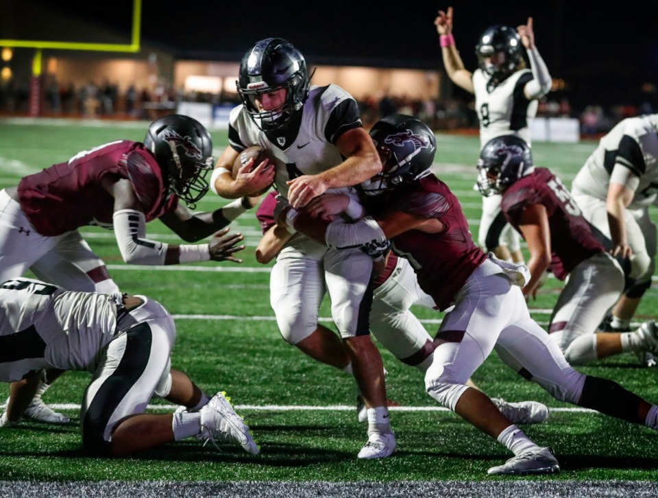 <strong>Houston running back Lincoln Pare (with ball) scores a touchdown despite the best efforts of the Collierville defense Oct. 10.</strong> (Mark Weber/Daily Memphian)