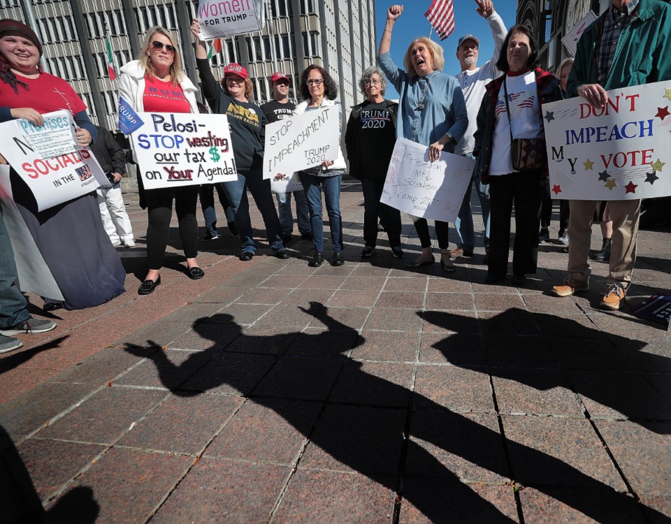 <strong>A shadow of George Montague falls across Civic Center Plaza as the 81-year-old Trump supporter talks during a rally Thursday to support President Donald Trump in light of an ongoing impeachment investigation in the U.S. House of Representatives.</strong> (Jim Weber/Daily Memphian)