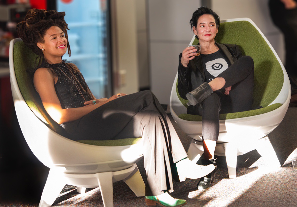 <strong>Valerie June and Maggie Louie, CEO of DEVCON, listen to the Joe Restivo Trio at the open house for DEVCON Oct. 17.</strong> (Greg Campbell/ Special to The Daily Memphian)