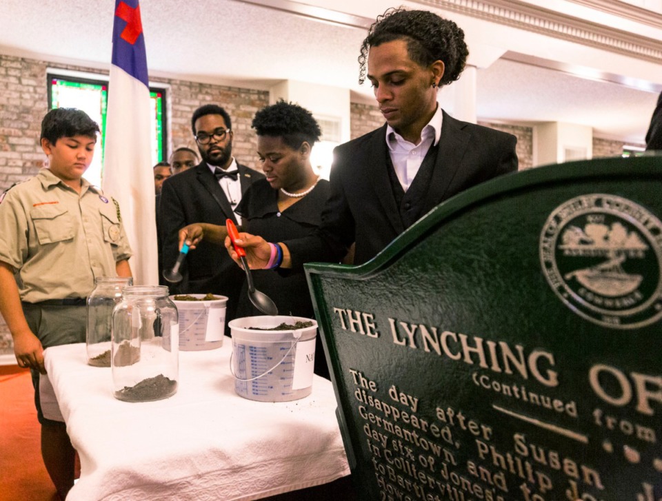 <strong>During the Lynching Site Project memorial at Collins CME Chapel Church in&nbsp;<span class="s1">Downtown Memphis on Oct. 19, 2019</span>, LeMoyne-Owen Choir members Emmanuel Lugo (from right), Dorneisha Bowling and Jon Turner place portions of earth in jars to represent paying respects at the burials of two Memphis lynching victims.</strong>&nbsp;<span class="s1">(Ziggy Mack/Special to The Daily Memphian)</span>