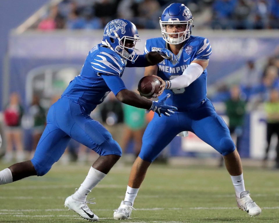 <strong>University of Memphis quarterback Brady White (right) shuffles the ball to running back Kylan Watkins during the Tigers game on Oct. 19, 2019, against the Green Wave at Liberty Bowl Memorial Stadium in Memphis.</strong> (Jim Weber/Daily Memphian)