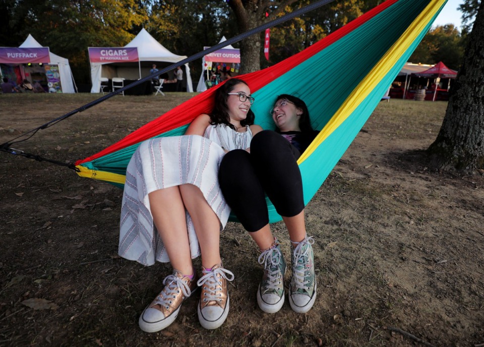 <strong>McKenna Hall (left) and Katie Dora Silkes (right) joke with each other while lounging in a hammock during the third annual Mempho Music Festival at Shelby Farms on Oct. 19, 2019.</strong> (Patrick Lantrip/Daily Memphian)