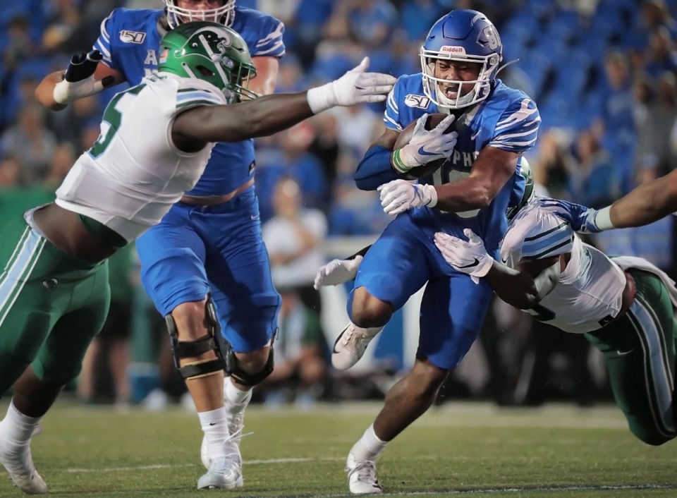 <strong>University of Memphis running back Kenneth Gainwell dodges Tulane defenders during the Tigers game on Oct. 19, 2019, against the Green Wave at Liberty Bowl Memorial Stadium in Memphis.</strong> (Jim Weber/Daily Memphian)