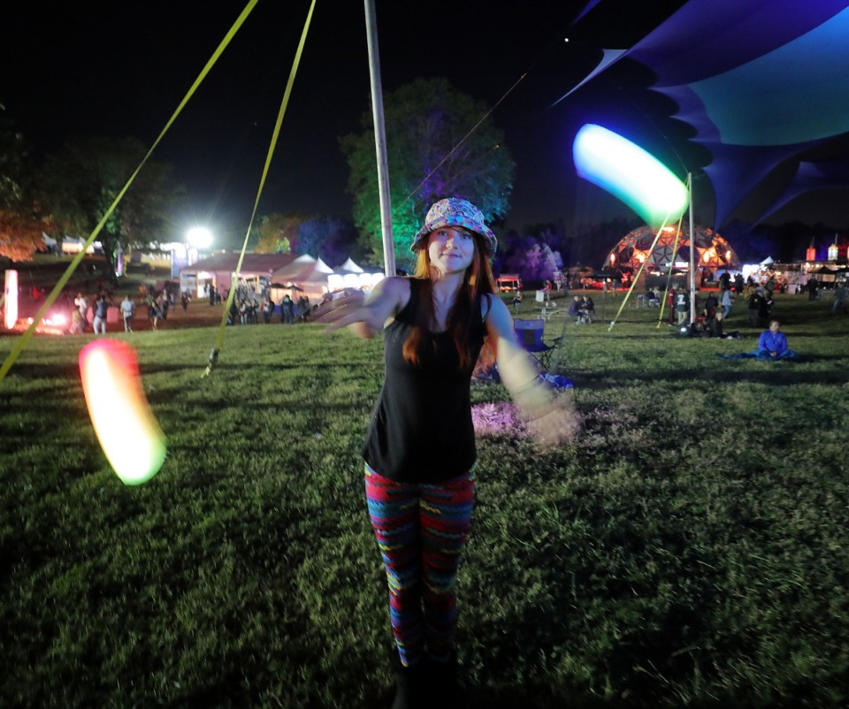<strong>Mary Katherine&nbsp; Cranford dances with neon lights during The Raconteurs' set at the third annual Mempho Music Festival at Shelby Farms on Oct. 19, 2019.</strong> (Patrick Lantrip/Daily Memphian)