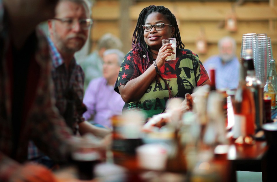 <strong>Ebony Cohran tries a drink at the tiki bar during the opening night of Back Do / Mi Yard, Karen Carrier's new patio venue in the Cooper-Young neighborhood.</strong> (Jim Weber/Daily Memphian)