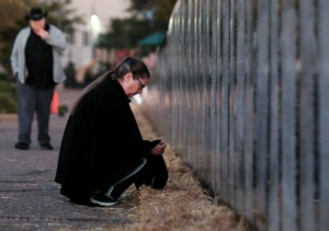 <strong>Ellie Vinson reflects in front of the Vietnam Traveling Memorial Wall in Collierville.</strong>&nbsp;<strong>The wall, which is illuminated around the clock, will remain at Central Church until Monday morning.</strong> (Patrick Lantrip/Daily Memphian)
