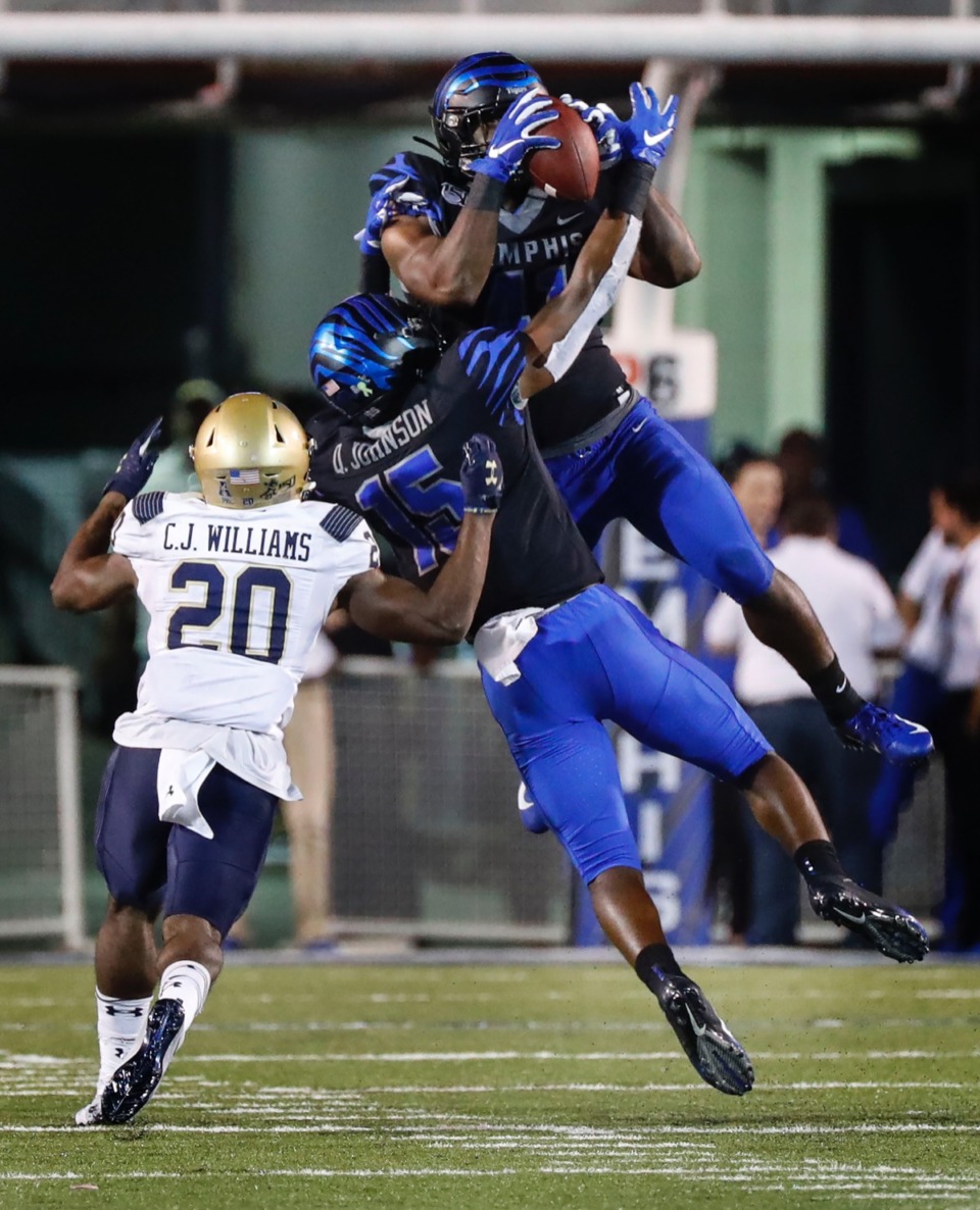 <strong>Before his injury, Sanchez Blake Jr. (top, grabbing an interception against Navy Sept. 26) was the team's starting safety and leading tackler.</strong> (Mark Weber/Daily Memphian)