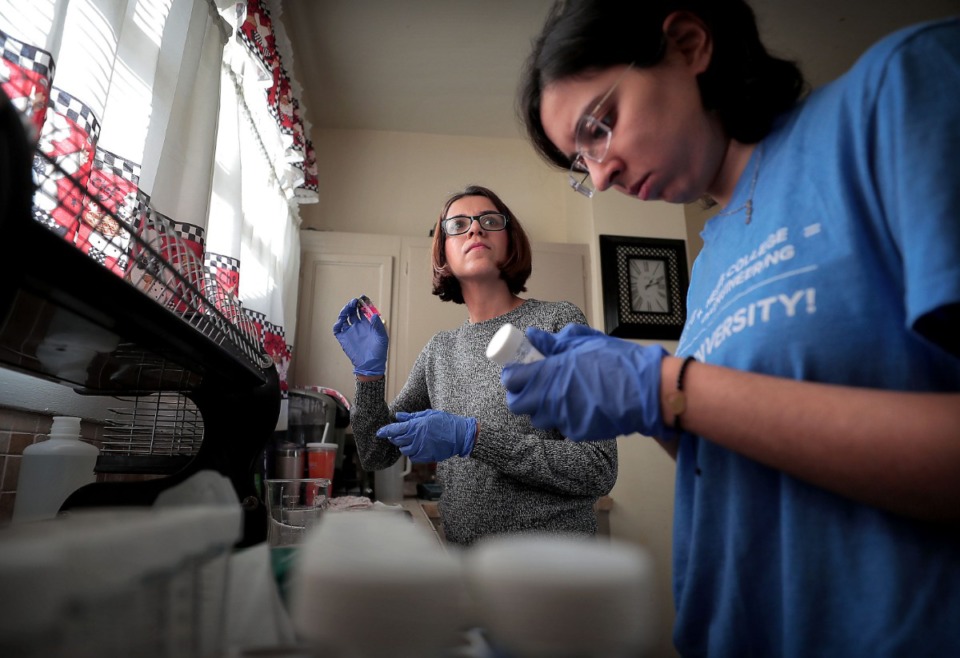 <strong>Civil engineering professor Maryam Salehi (left) and graduate assistant Donya Sharafoddinzadeh checked lead levels in a Midtown home Thursday.</strong> (Jim Weber/Daily Memphian)