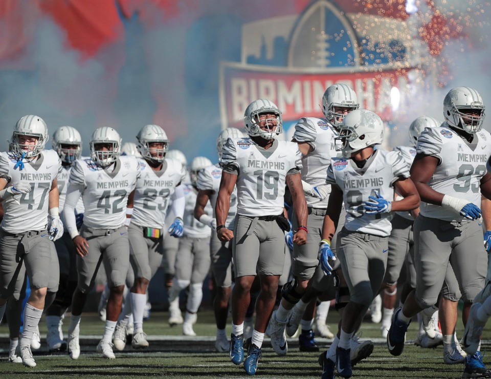<strong>University of Memphis players storm the field against Wake Forest at the start of the Birmingham Bowl on Dec. 22, 2018.</strong> (Jim Weber/Daily Memphian file)