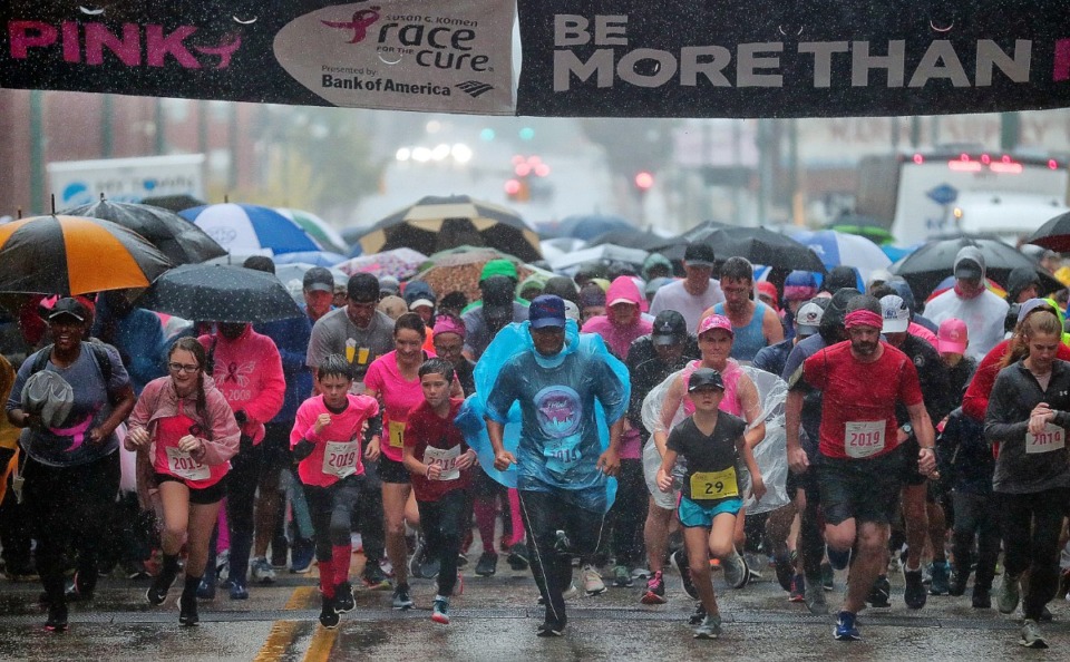 <strong>Breast cancer survivors, friends and family brave the heavy rain Downtown to run in the annual Susan G. Komen Race for the Cure on Oct. 26, 2019 to raise money to fund research, education, screening and treatment of breast cancer.</strong> (Jim Weber/Daily Memphian)