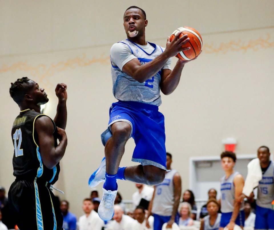 <strong>Memphis Tigers guard Alex Lomax (right) drives the lane against NPBA Select defender Leonardo Collie (left) during the Tigers' August exhibition game in Nassau, Bahamas.</strong> (Mark Weber/Daily Memphian file)