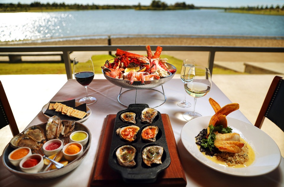 <strong>The grand seafood tower &mdash;&nbsp;charbroiled oysters (center), oysters with savory sorbets (left) and black grouper &mdash; get a lakeside view on the side at Coastal Fish Company.&nbsp;</strong>(Jim Weber/Daily Memphian)