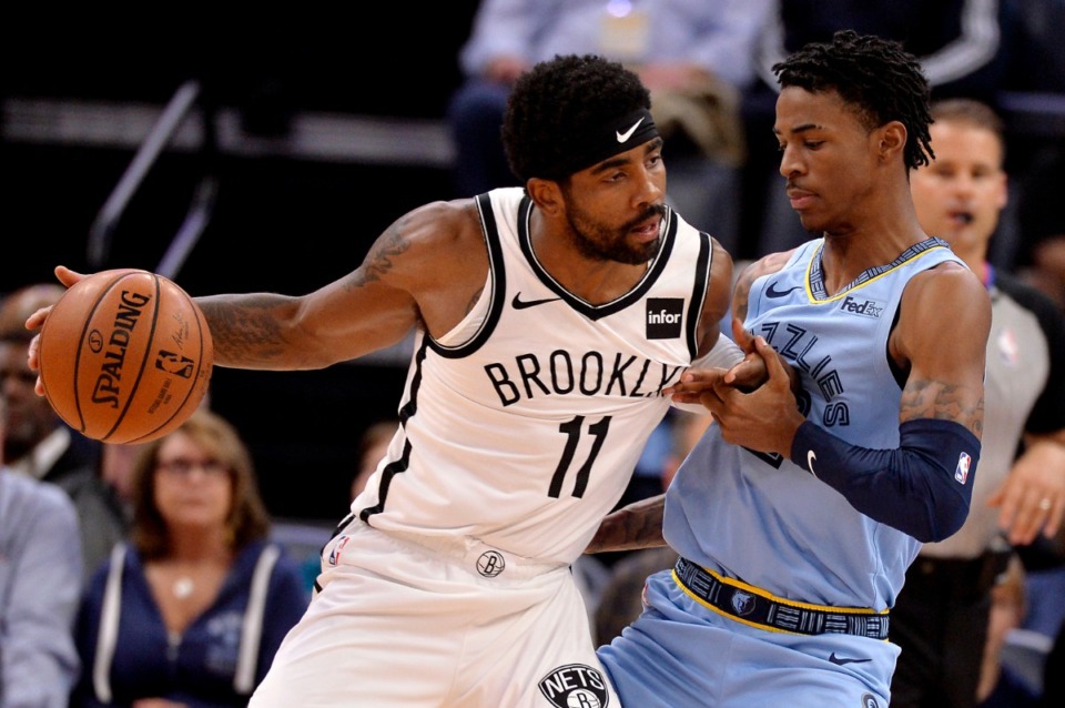 <strong>Brooklyn Nets guard Kyrie Irving (11) charges Grizzlies guard Ja Morant Oct. 27.</strong> (Brandon Dill/AP)