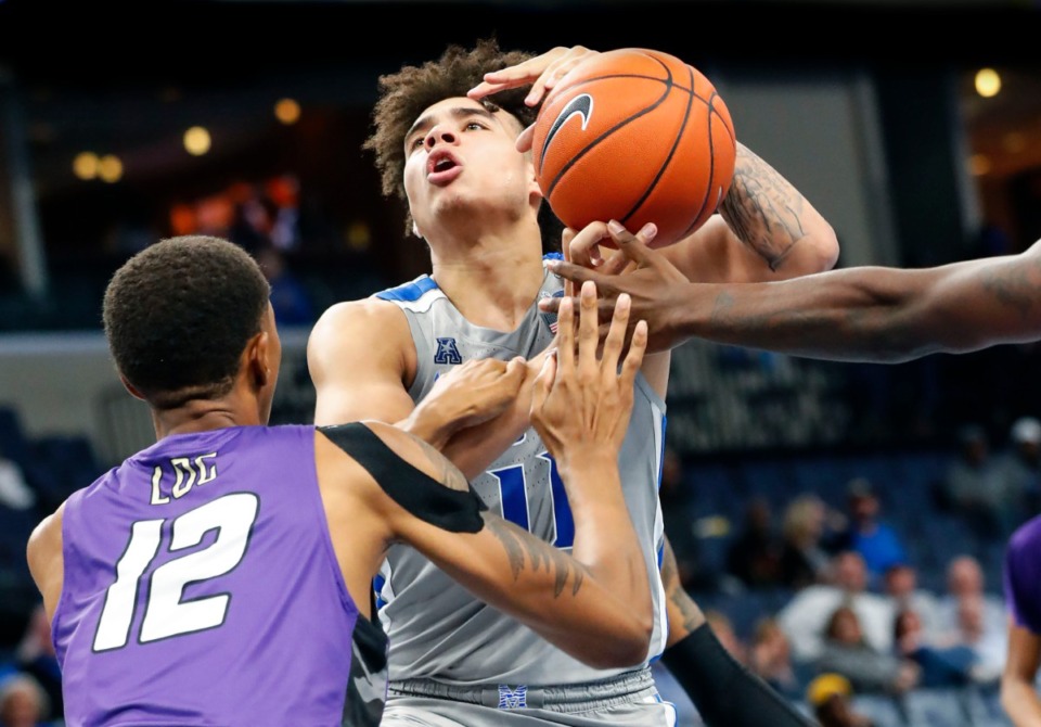 <strong>Memphis guard Lester Quinones (right) is fouled while driving the lane against LeMoyne-Owen defender Jaquan Lawrence Oct. 28.</strong> (Mark Weber/Daily Memphian)