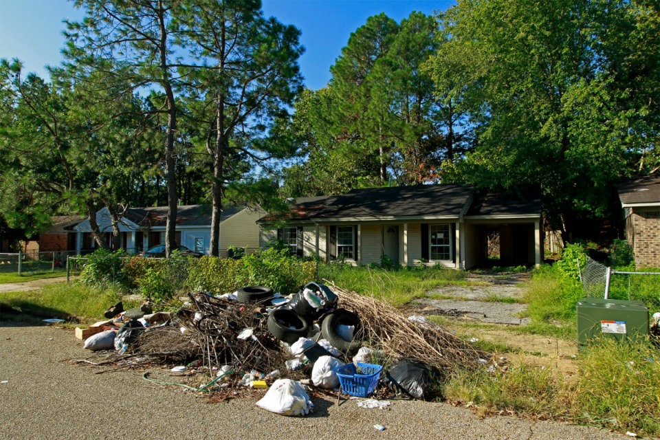 <strong>Illegal trash dumping, like in this file photo in front of an abandoned home in Northaven, is something residents there and Shelby County government hope can be minimized by starting trash pick-up service there.</strong> (Lance Murphey/Daily Memphian file)