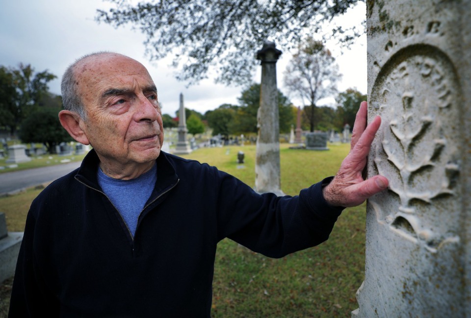 <strong>Memphis photographer Murray Riss admires the detail of the Jewish Tree of Life symbol on the gravestone of Gabriel Baum, who was buried in 1885, while visiting Temple Israel Cemetery in South Memphis on Oct. 29, 2019. The 78 year old took 12,000 images over the four seasons of one year at the cemetery, and 200 photos are featured in the new book "Beloved."</strong> (Patrick Lantrip/Daily Memphian)