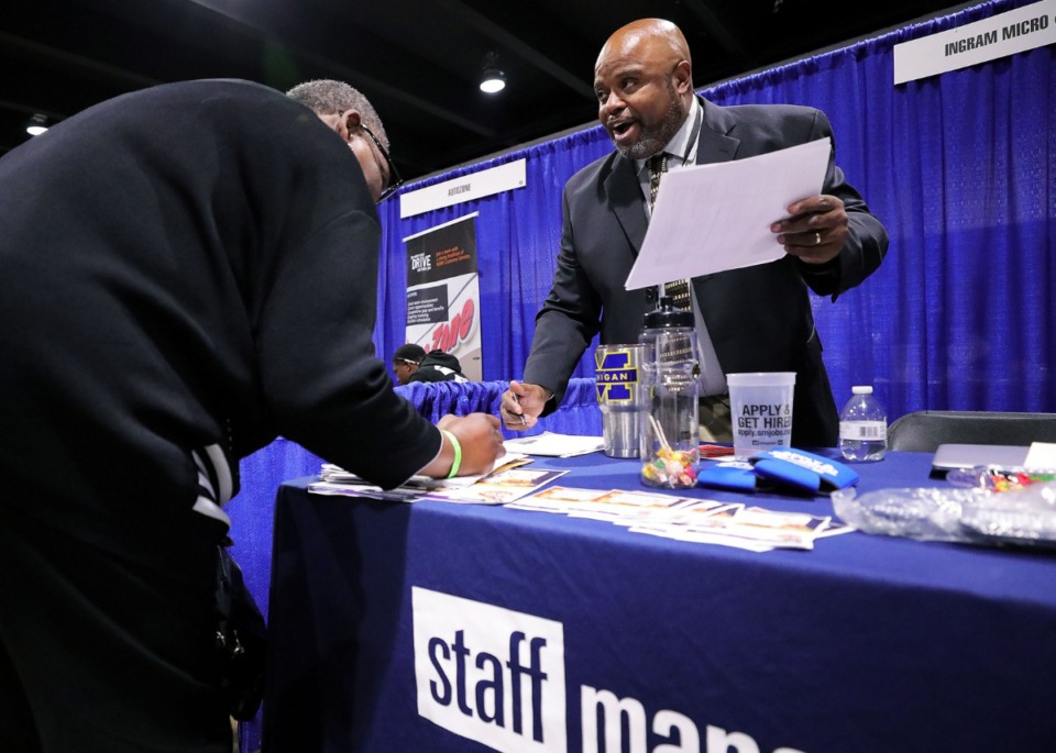 <strong>Bobby Fischer, a job recruiter with SMX, helps applicants fill out paper work at the Greater Memphis Chamber's Upskill901 Career Fair held at the Pipkin Building on Wednesday, Oct, 30.</strong> (Patrick Lantrip/Daily Memphian)