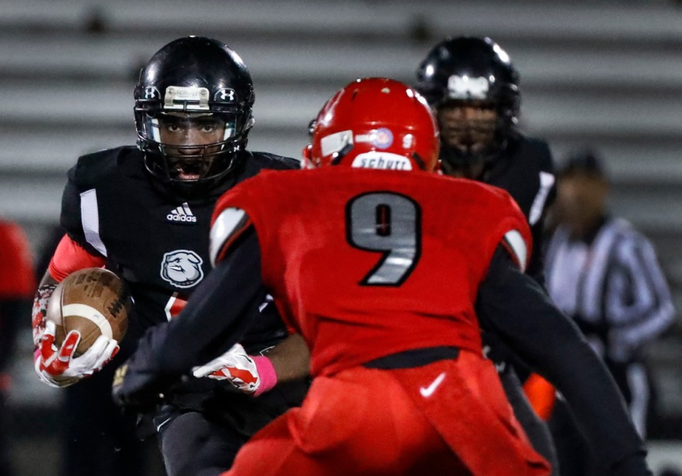 <strong>Middle College quarterback Benjamin Calvin (with ball) is confronted by Westwood's Amarion Marshall (9) Oct. 31.</strong> (Mark Weber/Daily Memphian)